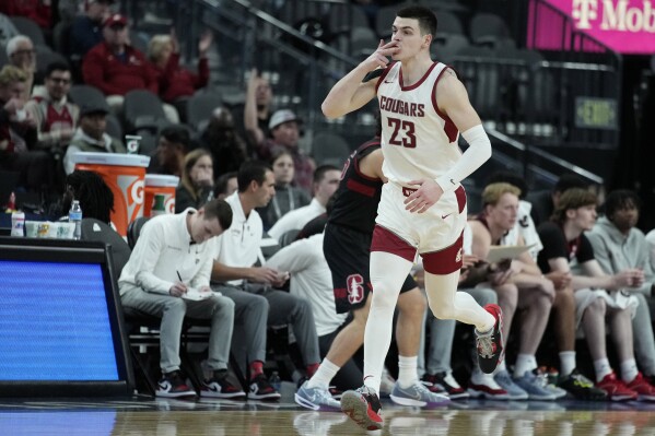 Washington State forward Andrej Jakimovski (23) celebrates after making a 3-point shot against Stanford during the first half of an NCAA college basketball game in the quarterfinal round of the Pac-12 tournament Thursday, March 14, 2024, in Las Vegas. (AP Photo/John Locher)