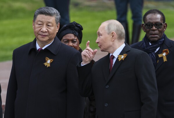 Chinese President Xi Jinping, left, Russian President Vladimir Putin, centre, and President of the Republic of Congo Denis Sassou Nguesso, right, attend a wreath laying ceremony at the Tomb of the Unknown Soldier in Alexander Garden after the Victory Day military parade in Moscow, Russia, Friday, May 9, 2025, during celebrations of the 80th anniversary of the Soviet Union's victory over Nazi Germany during the World War II. (Yuri Kochetkov/Pool Photo via AP)