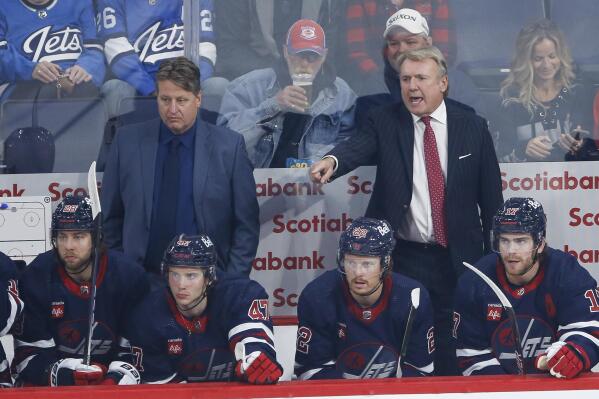 Winnipeg Jets coach Rick Bowness, right, calls to players during the first period of an NHL hockey preseason game against the Edmonton Oilers on Saturday, Oct. 1, 2022, in Winnipeg, Manitoba. (John Woods/The Canadian Press via AP)