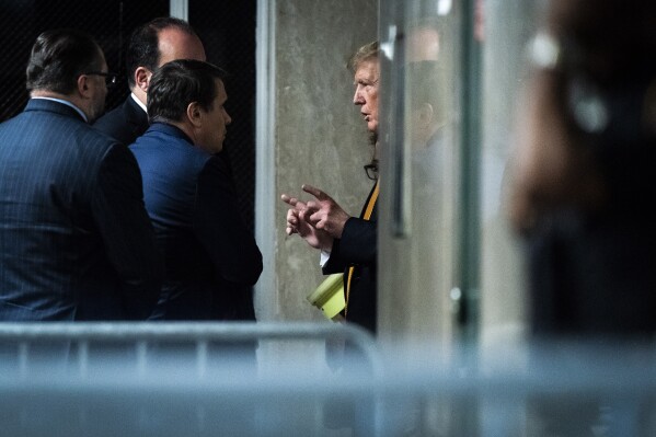 Former President Donald Trump speaks with attorney Todd Blanche and staff outside of the courtroom as jurors began deliberations for his criminal trial at Manhattan Criminal Court in New York on Wednesday, May 29, 2024. Trump was charged with 34 counts of falsifying business records last year, which prosecutors say was an effort to hide a potential sex scandal, both before and after the 2016 presidential election. Trump is the first former U.S. president to face trial on criminal charges. (Jabin Botsford/The Washington Post via AP, Pool)