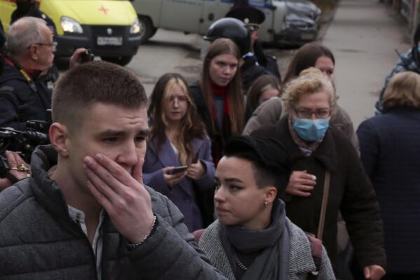 Students react as they gather outside the Perm State University in Perm, about 1,100 kilometers (700 miles) east of Moscow, Russia, Monday, Sept. 20, 2021. A gunman opened fire in a university in the Russian city of Perm on Monday morning, leaving at least eight people dead and others wounded, according to Russia's Investigative Committee. (AP Photo)