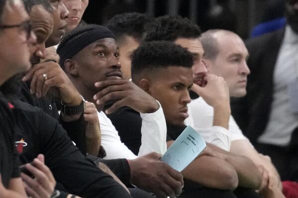 Miami Heat forward Jimmy Butler watches from the bench during the second half in Game 5 of the NBA basketball Eastern Conference finals against the Boston Celtics Thursday, May 25, 2023, in Boston. (AP Photo/Charles Krupa )