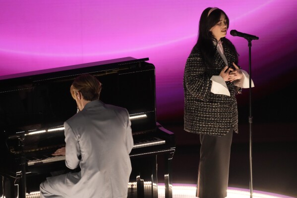 Finneas, left, and Billie Eilish perform "What Was I Made For?" from "Barbie" during the Oscars on Sunday, March 10, 2024, at the Dolby Theatre in Los Angeles. (AP Photo/Chris Pizzello)