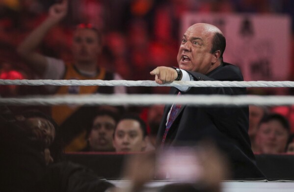 FILE - Manager Paul Heyman communicates with Brock Lesnar at WrestleMania XXXI in Santa Clara, Calif., Sunday, March 29, 2015. Heyman will be inducted into the WWE Hall of Fame during a ceremony at the Wells Fargo Center in Philadelphia on April 5. (Don Feria/AP Images for WWE, File)