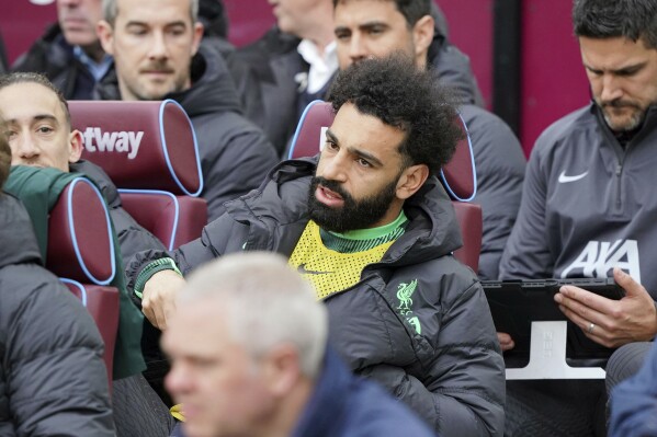 Liverpool's Mohamed Salah sits on the substitute bench ahead of the English Premier League match between West Ham United and Liverpool, at London stadium, in London, Saturday April 27, 2024. (Jonathan Brady/PA via AP)