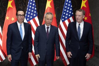 Chinese Vice Premier Liu He, center, poses with U.S. Trade Representative Robert Lighthizer, right, and Treasury Secretary Steven Mnuchin, for photos before holding talks at the Xijiao Conference Center in Shanghai Wednesday, July 31, 2019. (AP Photo/Ng Han Guan, Pool)