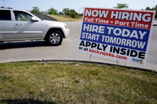 A hiring sign shows in Vernon Hills, Ill., Friday, June 11, 2021. Barely more than a year after the coronavirus caused the steepest economic fall and job losses on record, the speed of the rebound has been so unexpectedly swift that many companies can't fill jobs or acquire enough supplies to meet a pent-up burst of customer demand. (AP Photo/Nam Y. Huh)