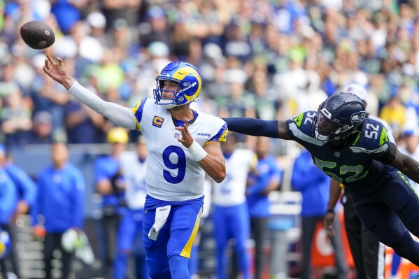 Los Angeles Rams quarterback Matthew Stafford passes under pressure from Seattle Seahawks linebacker Darrell Taylor during the second half of an NFL football game Sunday, Sept. 10, 2023, in Seattle. (AP Photo/Lindsey Wasson)