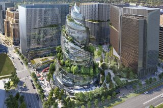 FILE - This artist rendering provided by Amazon shows the next phase of the company's headquarters redevelopment to be built in Arlington, Va. The plans released Tuesday, Feb. 2, 2021, features a 350-foot helix-shaped office tower that can be climbed from the outside like a mountain hike. Amazon is making its first foray into providing health care services, announcing Wednesday, March 17, 2021, that it will be offering its Amazon Care telemedicine program to employers nationwide. (NBBJ/Amazon via AP, File)