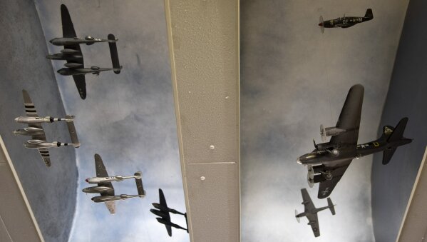In this photo taken on Thursday, Nov. 7, 2019, a collection of World War II planes hang from the ceiling at the Remember Museum 39-45 in Thimister-Clermont, Belgium. The museum houses countless World War II objects, but it's most important collection are stories and photos of those who served in World War II, mostly during the Battle of the Bulge. Veterans of the WWII Battle of the Bulge are heading back to mark, perhaps the greatest battle in U.S. military history, when 75-years ago Hitler launched a desperate attack deep through the front lines in Belgium and Luxembourg to be thwarted by U.S. forces.(AP Photo/Virginia Mayo)