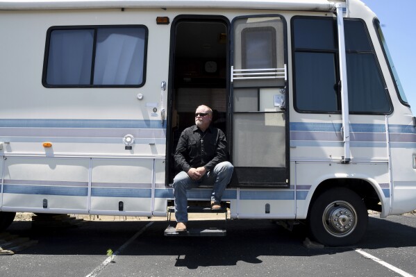 Joe Ridenour sits for a portrait on the steps of the recreational vehicle he once called home in Castle Rock, Colo., on Friday, July 12, 2024. Ridenour said he would have been consumed by his drug abuse if not for the help and shelter provided by The Rock non-denominational evangelical church. (ĢӰԺ Photo/Thomas Peipert)