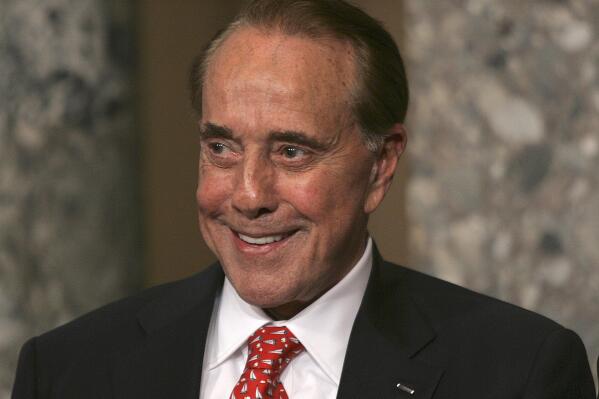 FILE - Former Senate Majority Leader Bob Dole, R-Kan., attends the unveiling of his portrait at the U.S. Capitol, in Washington, July 25, 2006. Bob Dole, who overcame disabling war wounds to become a sharp-tongued Senate leader from Kansas, a Republican presidential candidate and then a symbol and celebrant of his dwindling generation of World War II veterans, has died. He was 98. 
His wife, Elizabeth Dole, posted the announcement Sunday, Dec. 5, 2021, on Twitter. (AP Photo/Lawrence Jackson, File)