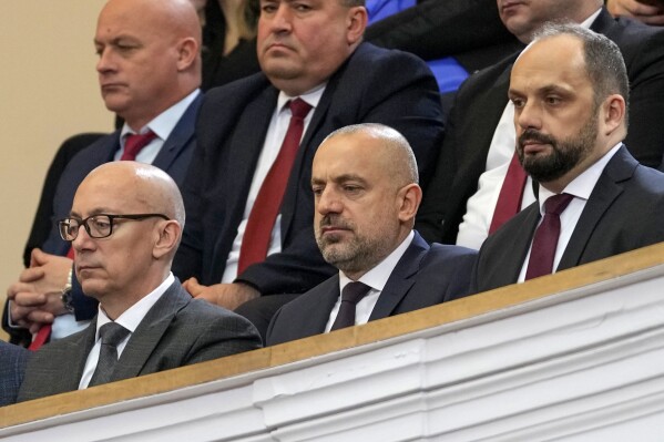 Politician and wealthy businessman Milan Radoicic, center, Serb List leader Goran Rakic, left, and former mayor of the Serb part of the ethnically divided town of Mitrovica Milan Radojevic attend a special session of Serbia's parliament about the negotiating process with Kosovo, in Belgrade, Serbia on Feb. 2, 2023. Serbian police on Tuesday detained an ethnic Serb leader Milan Radoicic from Kosovo who was the alleged organizer behind a recent shootout with Kosovo police that left four people dead and sent tensions soaring in the region. (AP Photo/Darko Vojinovic, File)