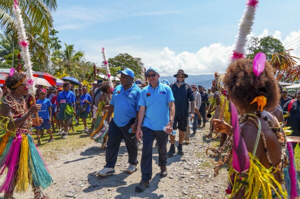 In this image supplied by the Australian Prime Ministers office, Australian Prime Minister Anthony Albanese, centre right, walks with Papua New Guinea Prime Minister James Marape as they start their trek along the Kokoda Track at Kokoda Village, Papua New Guinea, Tuesday, April 23, 2024. The prime ministers on Tuesday began trekking into the South Pacific island nation’s mountainous interior to commemorate a pivotal World War II campaign and to underscore their current security alliance that is challenged by China's growing regional influence. (Prime Ministers office via AP)