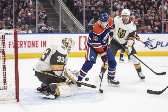 Vegas Golden Knights goalie Adin Hill (33) makes the save on Edmonton Oilers' Zach Hyman (18) during the second period of an NHL hockey game in Edmonton, Alberta on Wednesday April 10, 2024.(Jason Franson/The Canadian Press via AP)