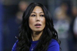 FILE - Buffalo Bills co-owner Kim Pegula stands on the field before an NFL football game in Arlington, Texas, Nov. 28, 2019. Bills co-owner Pegula watched training camp practice from the front seat of the family's SUV on Sunday, July 30, 2023, in making an encouraging first public appearance in 14 months since experiencing a debilitating cardiac arrest. (AP Photo/Michael Ainsworth, File)