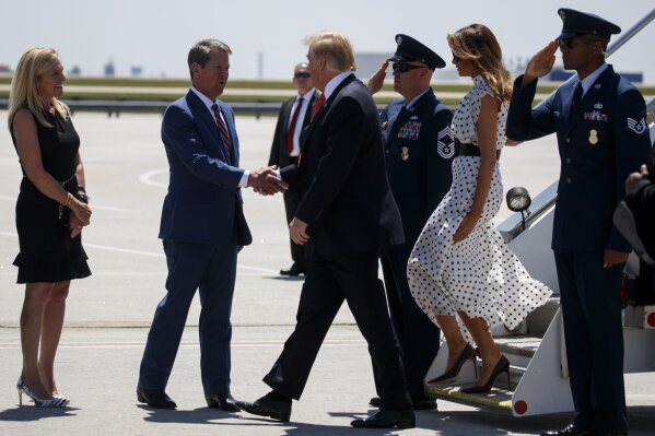 
              Georgia Gov. Brian Kemp, R-Ga., and his wife Marty Kemp greet President Donald Trump and first lady Melania Trump as they arrive at Hartsfield-Jackson International Airport to attend the "Rx Drug Abuse and Heroin Summit," Wednesday, April 24, 2019, in Atlanta. (AP Photo/Evan Vucci)
            