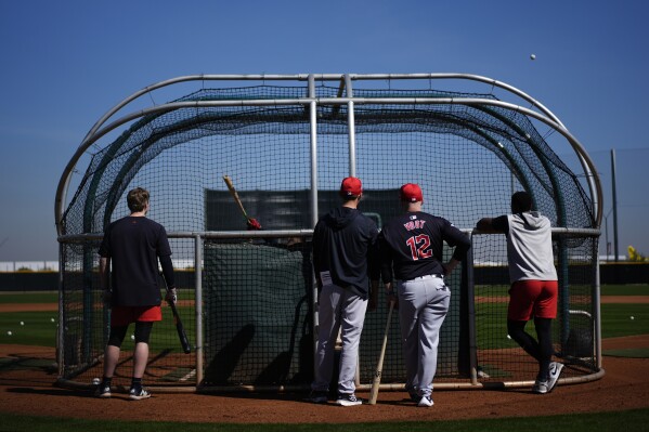 Cleveland Guardians manager Stephen Vogt (12) watches batting practice during spring training baseball workouts in Goodyear, Ariz., on Friday, Feb. 16, 2024. (AP Photo/Carolyn Kaster)