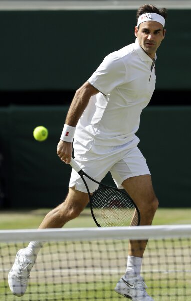 Switzerland's Roger Federer plays a shot to Serbia's Novak Djokovic during the men's singles final match of the Wimbledon Tennis Championships in London, Sunday, July 14, 2019. (AP Photo/Ben Curtis)