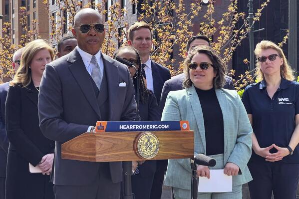 New York Mayor Eric Adams, left, introduces Kathleen Corradi, center, as the city's first-ever citywide director of rodent mitigation, also known as the "rat czar," in New York, Wednesday, April 12, 2023. (AP Photo/Bobby Caina Calvan)