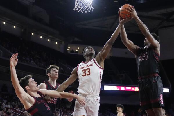 Southern California forward Kijani Wright (33) reaches for a rebound next to Stanford forward Harrison Ingram (55), guard Michael O'Connell (5) and forward Maxime Raynaud (42) during the second half of an NCAA college basketball game Saturday, Feb. 18, 2023, in Los Angeles. (AP Photo/Marcio Jose Sanchez)