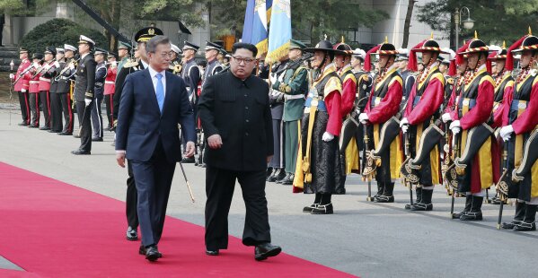 
              North Korean leader Kim Jong Un, second from left, and South Korean President Moon Jae-in, left, inspect an honor guard after Kim crossed the border into South Korea for their historic face-to-face talks, in Panmunjom Friday, April 27, 2018. Kim made history Friday by crossing over the world's most heavily armed border to greet his rival, Moon, for talks on North Korea's nuclear weapons. (Korea Summit Press Pool via AP)
            