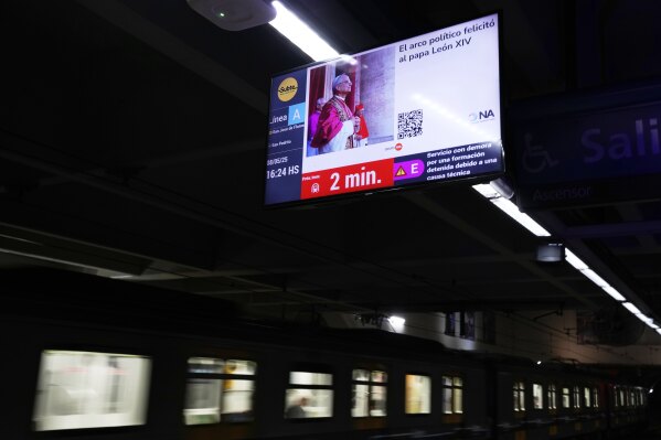 A screen at the subway displays a picture of newly elected Pope Leo XIV in Buenos Aires, Argentina, Thursday, May 8, 2025. (AP Photo/Natacha Pisarenko)