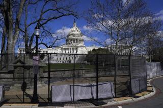 FILE - In this April 2, 2021, file photo the U.S. Capitol is seen behind security fencing on Capitol Hill in Washington. The fencing installed around the Capitol after the deadly Jan. 6 insurrection will start being removed as soon as Friday, July 9, but most visitors are still not allowed inside the iconic building. (AP Photo/Carolyn Kaster, File)