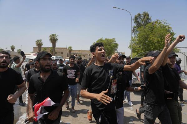 Supporters of Iraqi Shiite cleric Muqtada al-Sadr protest in front the Supreme Judicial Council, in Baghdad, Iraq, Tuesday, Aug. 23, 2022. Dozens of supporters of al-Sadr, an influential Shiite cleric in Iraq, rallied on Tuesday in Baghdad’s heavily-fortified Green Zone, demanding the dissolution of parliament and early elections. The demonstration underscored how intractable Iraq's latest political crisis has become. (AP Photo/Hadi Mizban)