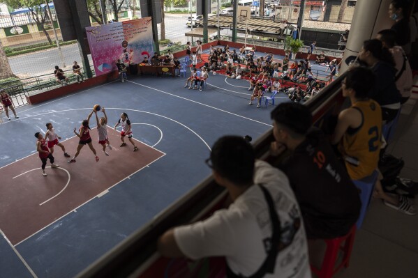 People watch a women's basketball tournament in Ho Chi Minh City, Vietnam, Jan. 14, 2024. (AP Photo/Jae C. Hong)