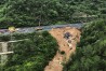 In this photo released by Xinhua News Agency, an aerial photo shows rescuers working at the site of a collapsed road section of the Meizhou-Dabu Expressway in Meizhou, south China's Guangdong Province, Wednesday, May 1, 2024. A section of a highway collapsed early Wednesday in southern China, sending cars tumbling and leaving more than a dozen of people dead, according to state media. (Xinhua News Agency via AP)