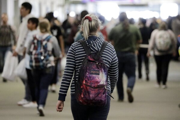In this Nov. 14, 2019, photo, students walk on the campus of Utah Valley University, in Orem, Utah. More college students are turning to their schools for help with anxiety, depression and other mental health problems. That's according to an Associated Press review of more than three dozen public universities. (AP Photo/Rick Bowmer)