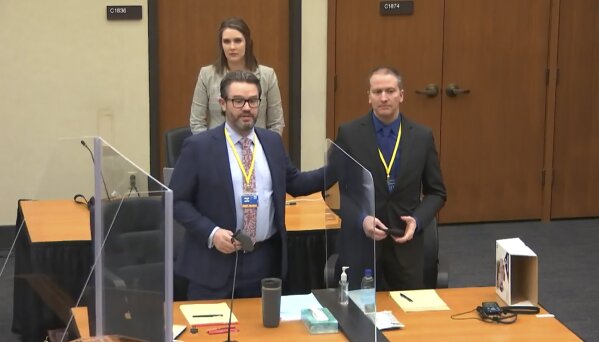 In this screen grab from video, defense attorney Eric Nelson, left, defendant and former Minneapolis police officer Derek Chauvin, right, and Nelson's assistant Amy Voss, back, introduce themselves to potential jurors as Hennepin County Judge Peter Cahill Tuesday, March 23, 2021, presides over jury selection in the trial of Chauvin at the Hennepin County Courthouse in Minneapolis, Minn.   Chauvin is charged in the May 25, 2020 death of George Floyd.  (Court TV, via AP, Pool)