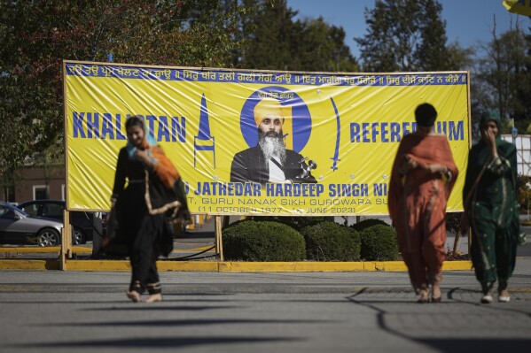 FILE - A banner that shows the late Sikh separatist leader Hardeep Singh Nijjar is displayed outside the Guru Nanak Sikh Gurdwara Sahib in Surrey, British Columbia, Sept. 18, 2023, where he was gunned down in his vehicle while leaving the temple parking lot. Canadian police said Friday, May 3, 2024, that they have made three arrests in the June slaying. (Darryl Dyck/The Canadian Press via AP, File)