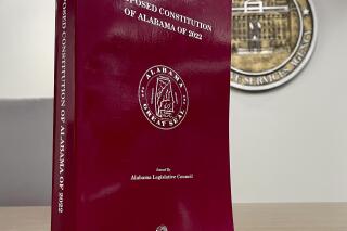 A copy of the proposed constitution of Alabama of 2022 is seen at the statehouse in Montgomery, Ala., on Tuesday, Nov. 1, 2022. Alabama voters on Nov. 8 will vote whether to ratify a recompiled Alabama Constitution that strips racist language and deleted repealed and redundant sections. The state's governing document will remain the longest in the United States at over 300,000 words. (AP Photo/Kim Chandler)