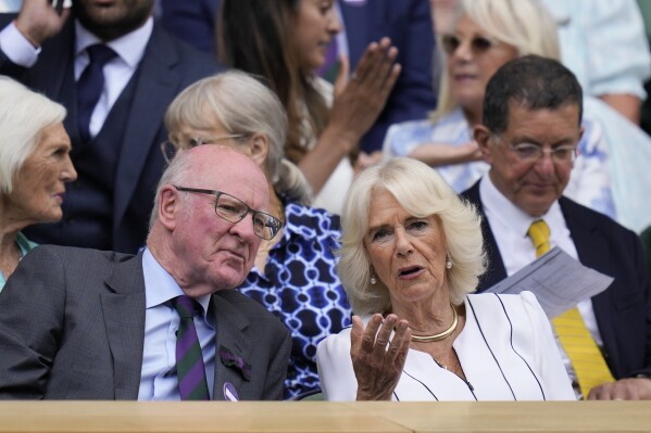 Britain's Queen Camilla speaks with Ian Hewitt, the chairman of the AELTC as she sits in the Royal Box on Centre court on day ten of the Wimbledon tennis championships in London, Wednesday, July 12, 2023. (AP Photo/Kirsty Wigglesworth)
