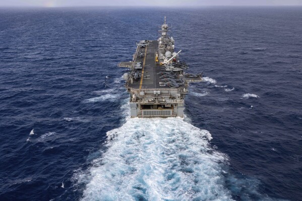In this handout photo from the U.S. Navy, the Wasp-class amphibious assault ship USS Bataan travels through Atlantic Ocean on July 20, 2023. Thousands of Marines backed by the United States' top fighter jet, warships and other aircraft are slowly building up in the Persian Gulf. It's a sign that while America's wars in the region may be over, its conflict with Iran over its advancing nuclear program only continues to worsen with no solutions in sight. (Mass Communication Specialist 2nd Class Danilo Reynoso/U.S. Navy, via AP)