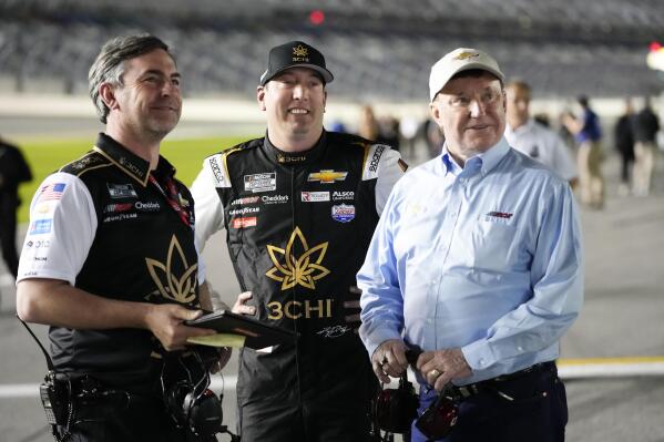 Kyle Busch, center, stands on pit road with his crew chief Randall Burnett, left, and car owner Richard Childress during qualifying for the NASCAR Daytona 500 auto race at Daytona International Speedway, Wednesday, Feb. 15, 2023, in Daytona Beach, Fla. (AP Photo/John Raoux)
