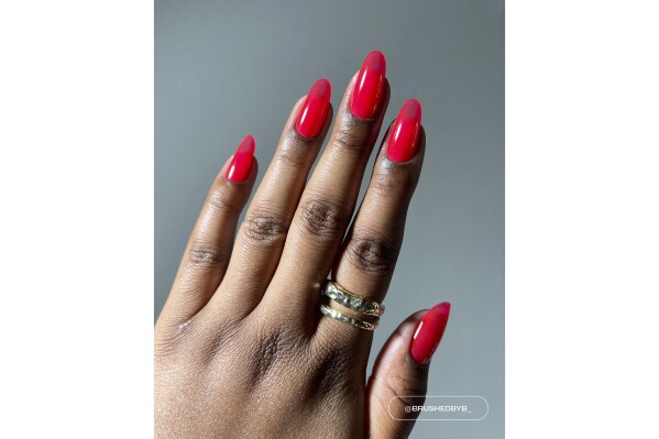 This photo provided by Lights Lacquer shows Razzle Red, a translucent jelly. On Valentine's Day, why not express love on your fingernails? Julie Kandalec is a celebrity manicurist who notes some fun new trends. She says that traditionally, Valentine's nails were simple — solid red, a simple pink heart or a French manicure. Thanks to social media, there are now lots of ideas to try. (Lights Lacquer via AP)