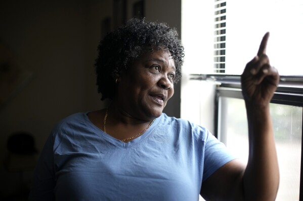 Bobbie Boyd talks about this summer's heat in her apartment Wednesday, Aug. 9, 2023, in Fayetteville, Ark. On a fixed income, Boyd sacrifices meals, health care, and car insurance among other necessities to pay rent and keep cool in the midst of this summer's prolonged heat waves. (AP Photo/Charlie Riedel)