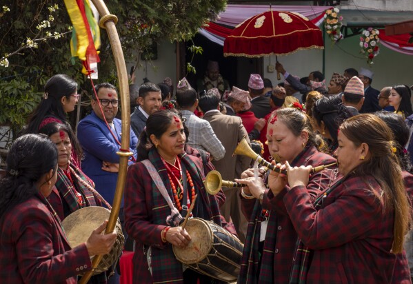 Members of Shrijanshil Mahila Sanstha, or the Self-Reliant Women’s Group, plays at a wedding in Kathmandu, Nepal, Wednesday, March 6, 2024. (AP Photo/Niranjan Shrestha)