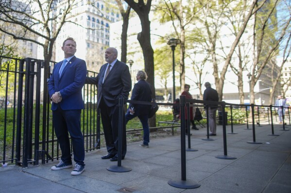 Andrew Giuliani, left, son of former New York City Mayor Rudy Giuliani, stands on line outside Manhattan criminal court building for a chance to get inside the courtroom to watch the proceedings in former President Donald Trump's criminal trial, Monday, April 22, 2024, in New York. (AP Photo/Mary Altaffer)