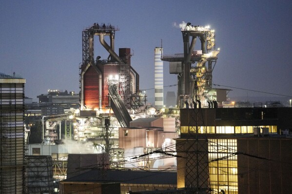 A blast furnace of German steel producer thyssenkrupp Steel Europe is in operation in the late evening in Duisburg, Germany, Wednesday, Oct. 11, 2023. The world is off track in its efforts to curb global warming, a new international report calculates Tuesday, Nov. 14. (AP Photo/Martin Meissner)