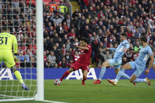 Liverpool's Mohamed Salah scores his side's second goal  during the English Premier League soccer match between Liverpool and Manchester City at Anfield, Liverpool, England, Sunday Oct. 3, 2021. (Peter Byrne/PA via AP)