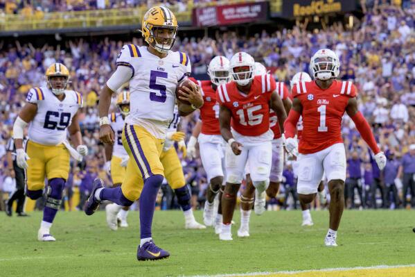 LSU quarterback Jayden Daniels (5) smiles as he scores a touchdown against Mississippi during the second half an NCAA college football game in Baton Rouge, La., Saturday, Oct. 22, 2022. (AP Photo/Matthew Hinton)