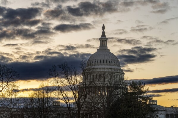 The Capitol is seen under a winter sky in Washington, Monday, Dec. 18, 2023, as White House and Senate negotiators are struggling to reach a U.S. border security deal that would unlock President Joe Biden's request for billions of dollars worth in military aid for Ukraine and national security. (AP Photo/J. Scott Applewhite)