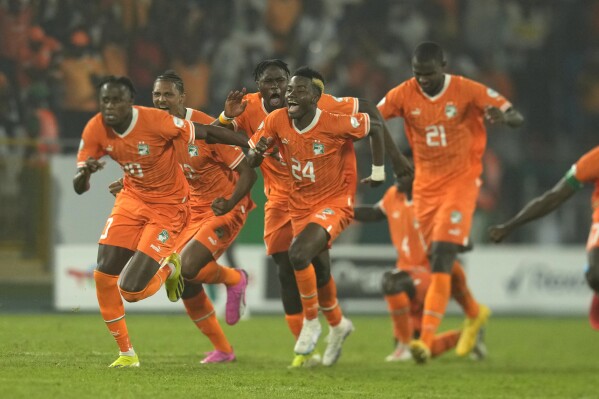 Ivory Coast players celebrate after defeating Senegal in a penalty shootout during their African Cup of Nations round of 16 soccer match between Senegal and Ivory Coast, at the Charles Konan Banny stadium in Yamoussoukro, Ivory Coast, Saturday, Jan. 20, 2024. (AP Photo/Themba Hadebe)