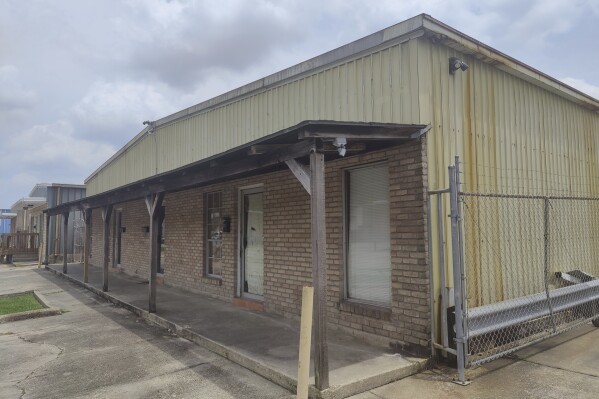 The front awning hangs from the dilapidated unapproved school named Second Chance Academy, in Baton Rouge, La., June 19, 2023. The school has come under scrutiny since its head teacher was arrested on charges of sexually abusing students. (Charles Lussier/The Advocate via AP)