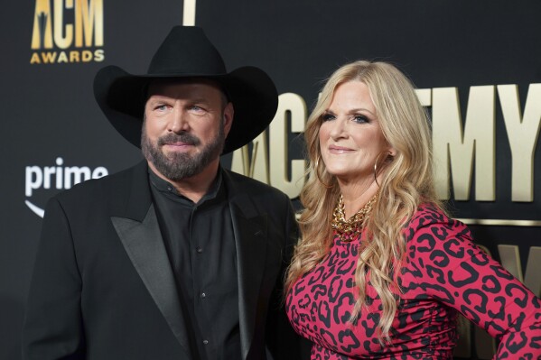 FILE - Garth Brooks, left, and Trisha Yearwood appear at the 58th annual Academy of Country Music Awards in Frisco, Texas on May 11, 2023. The couple hosted Habitat for Humanity's annual Jimmy and Rosalynn Carter Work Week Project, which began on Sunday. (AP Photo/Jeffrey McWhorter, File)