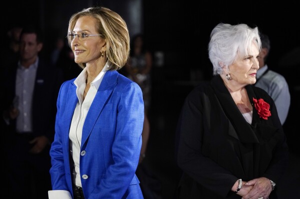 Republican candidates for Arizona governor Karrin Taylor Robson, left, and Paola Tulliani-Zen, right, arrive on the set prior to a PBS televised debate, on June 29, 2022, in Phoenix. (AP Photo/Ross D. Franklin, File)